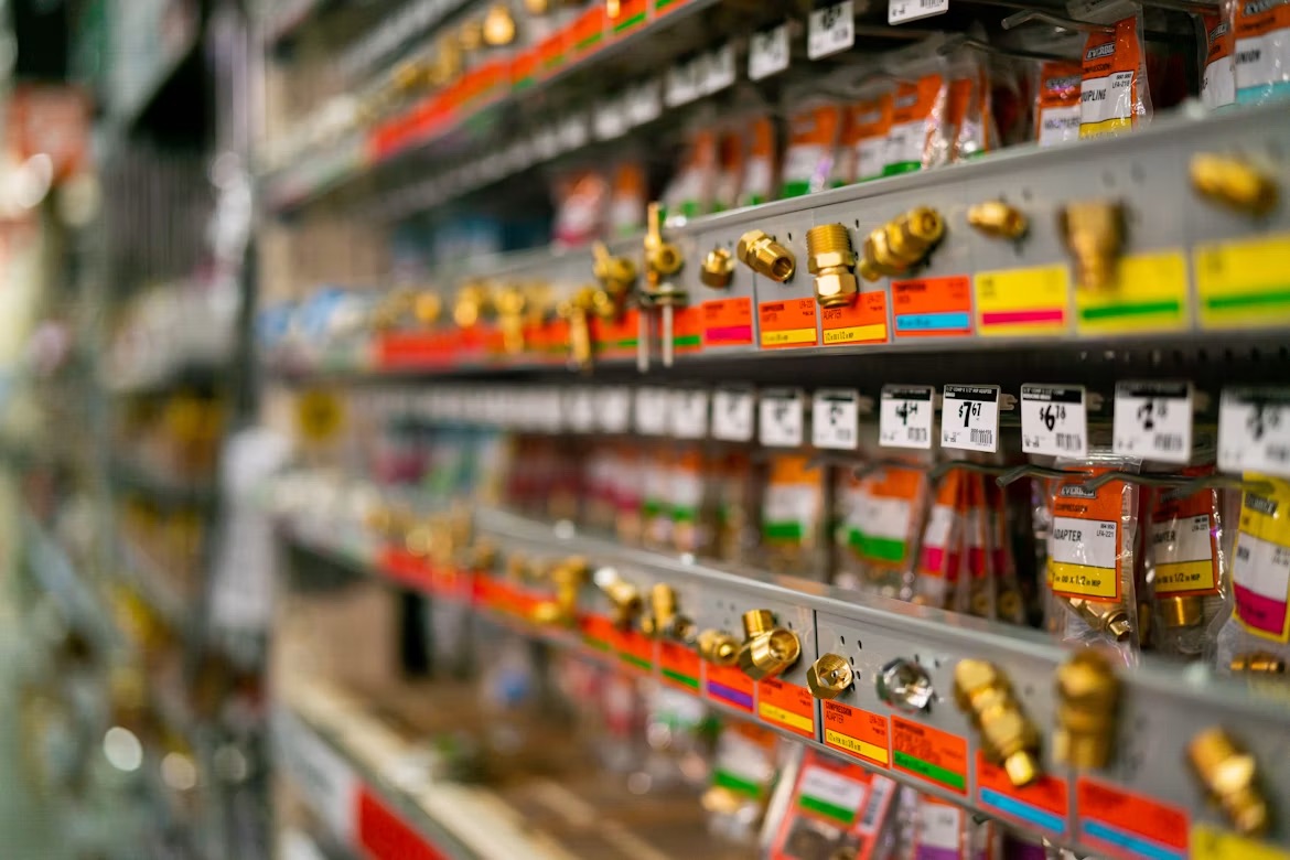 Shelves of brass plumbing fittings and valves at a trade merchant